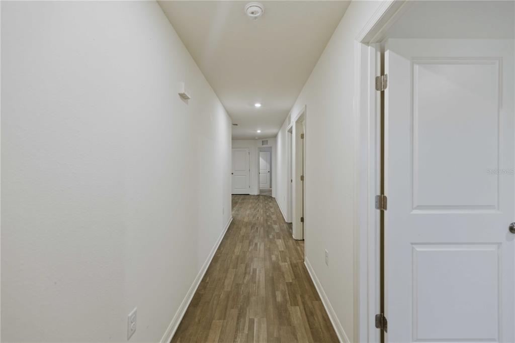 260 Emerald Road Ocala, FL 34472 - Photo 7 of 29 a view of a hallway with wooden floor and closet