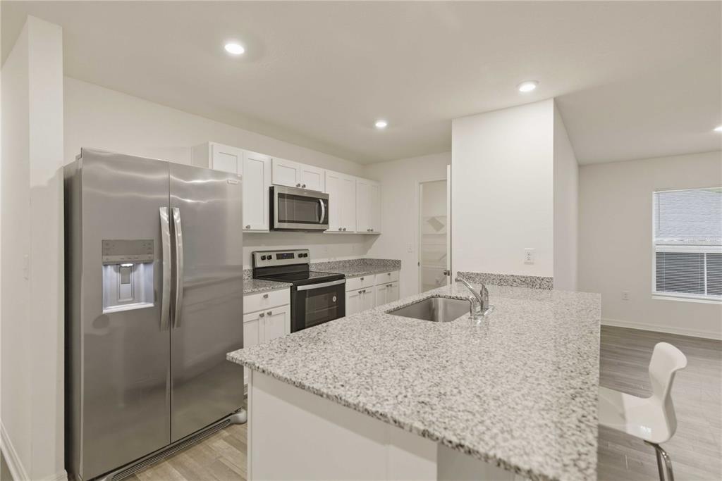 260 Emerald Road Ocala, FL 34472 - Photo 9 of 29 a kitchen with granite countertop a refrigerator stove and sink