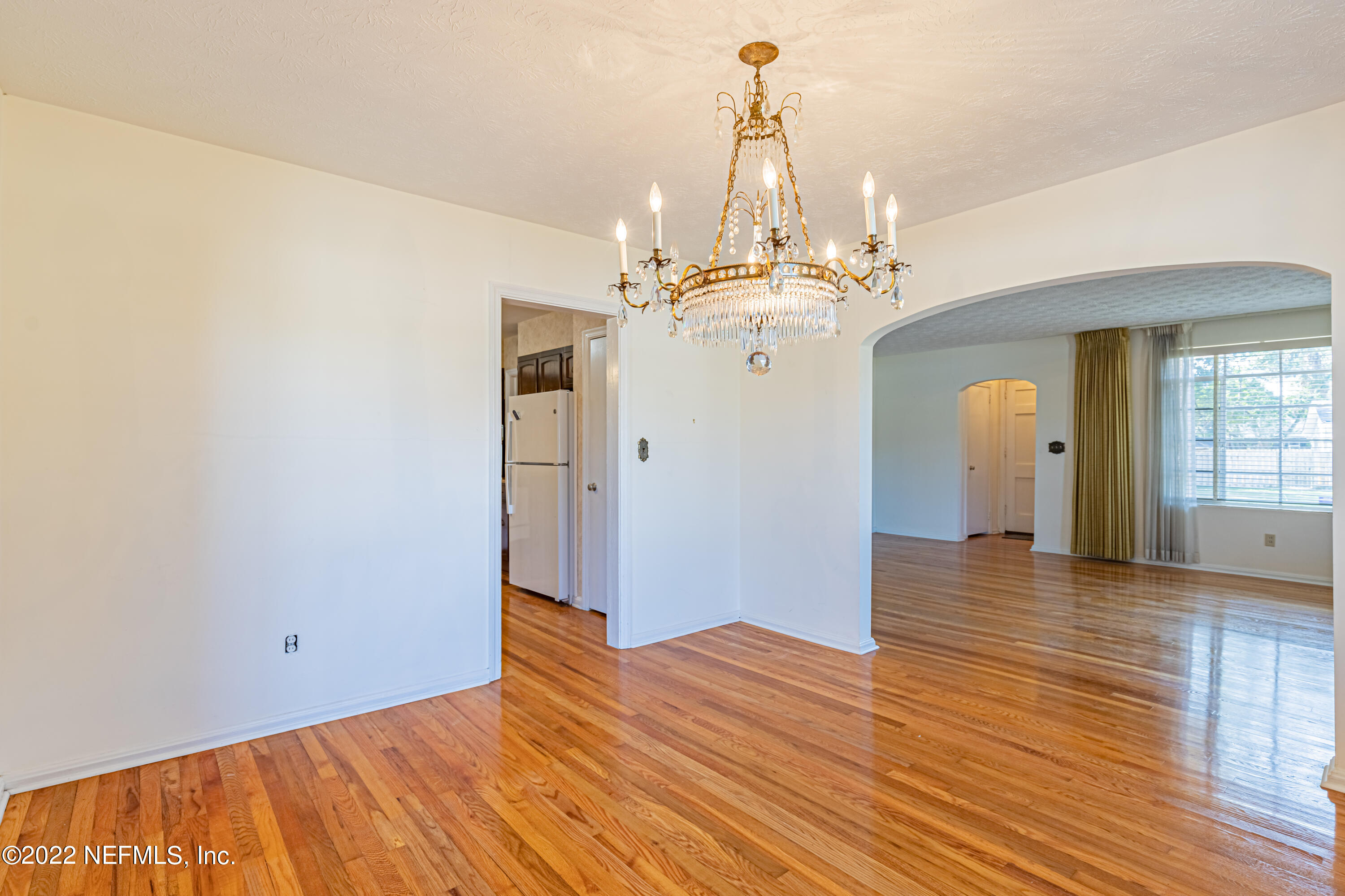 4209 Birmingham Road Jacksonville, FL 32207 - Photo 11 of 35 a view of a livingroom with wooden floor and a chandelier
