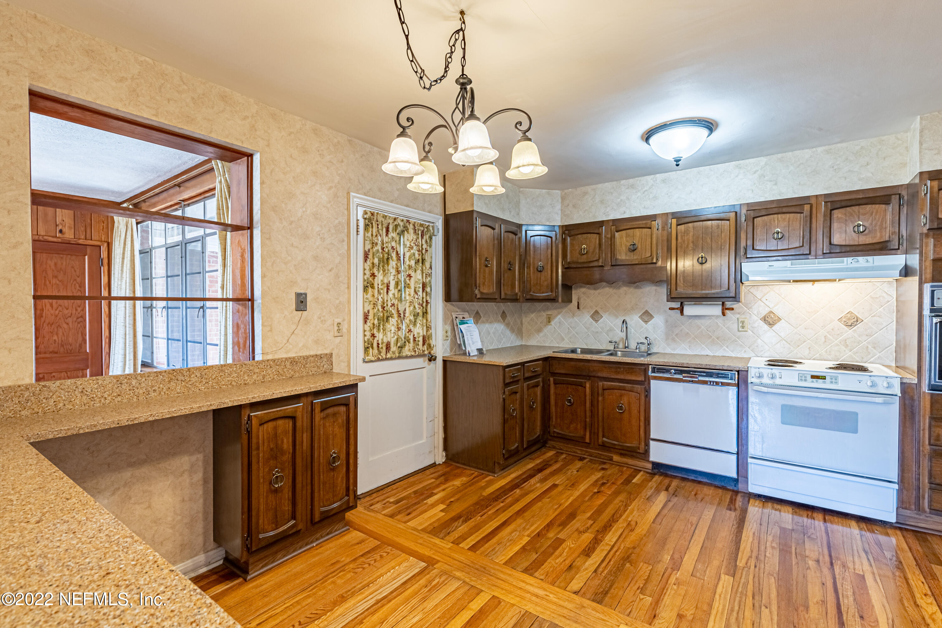 4209 Birmingham Road Jacksonville, FL 32207 - Photo 14 of 35 a kitchen with stainless steel appliances granite countertop wooden floors and granite counter tops