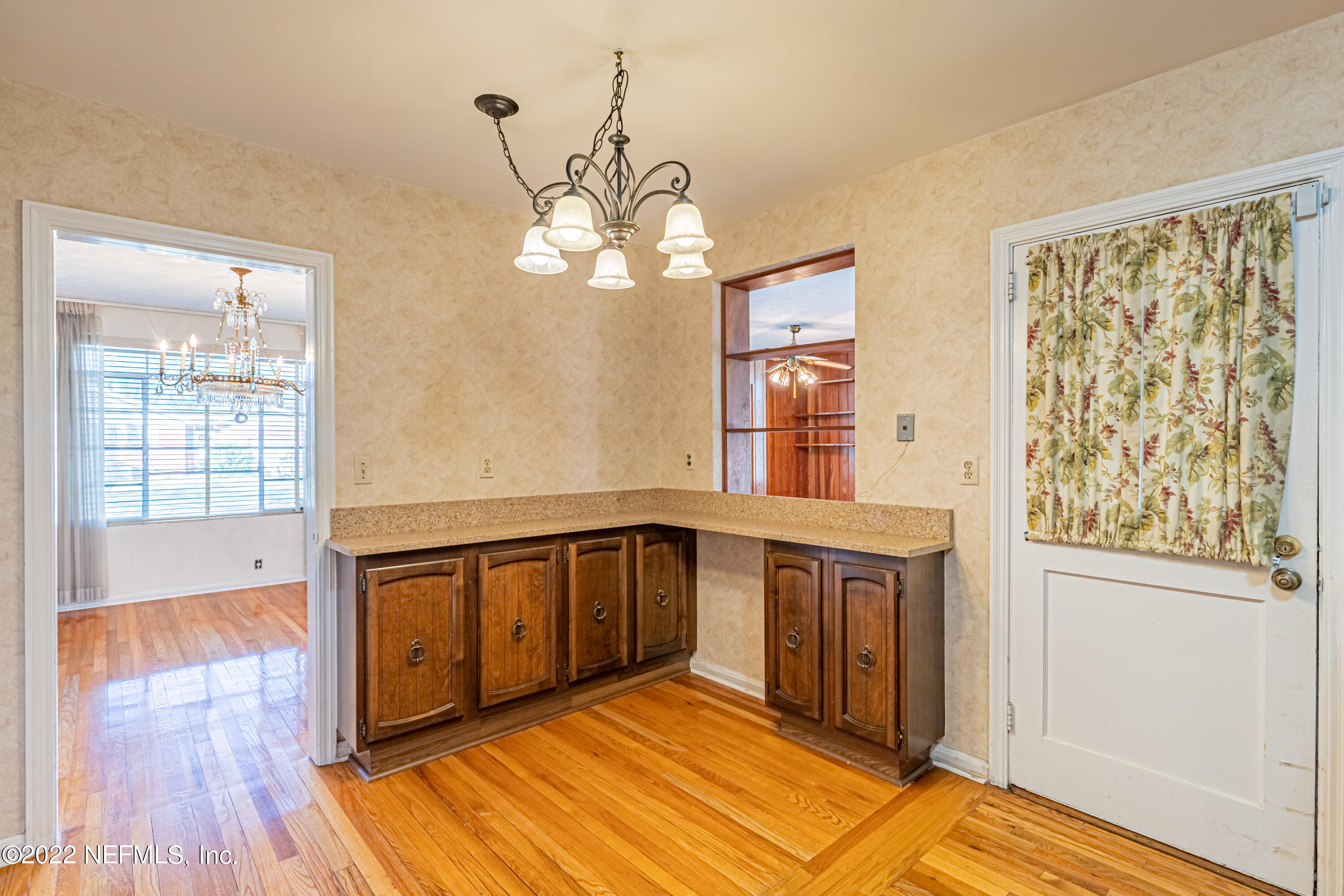 4209 Birmingham Road Jacksonville, FL 32207 - Photo 16 of 35 a view of a bedroom with wooden floor and a window