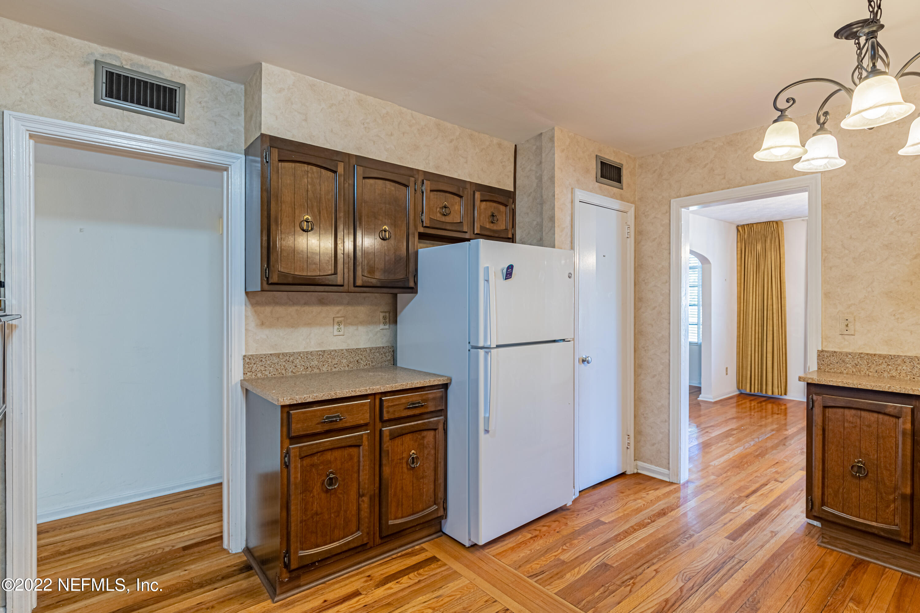 4209 Birmingham Road Jacksonville, FL 32207 - Photo 18 of 35 a kitchen with a refrigerator and wooden floor