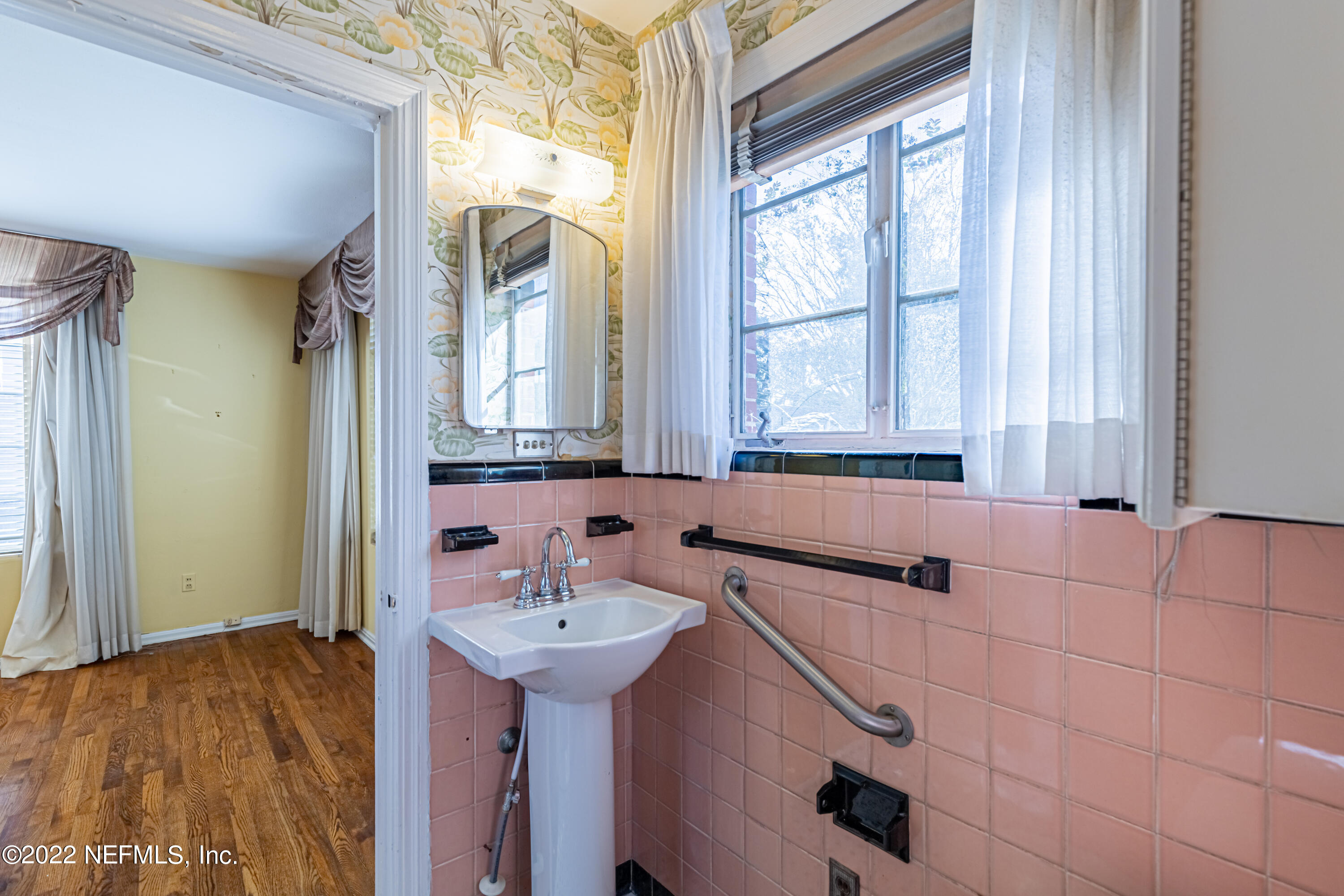 4209 Birmingham Road Jacksonville, FL 32207 - Photo 21 of 35 a bathroom with a sink and a mirror