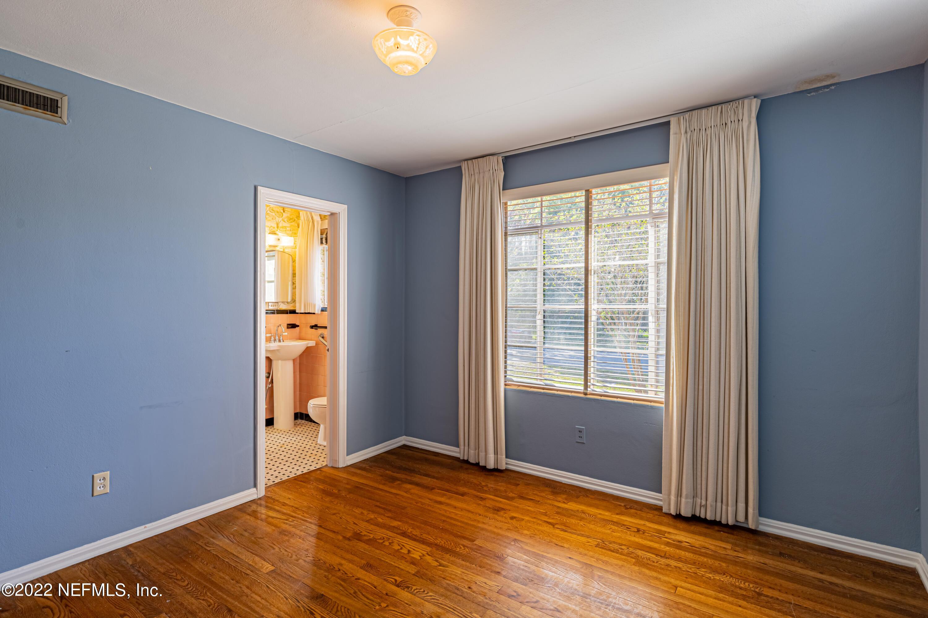 4209 Birmingham Road Jacksonville, FL 32207 - Photo 23 of 35 a view of empty room with window and wooden floor