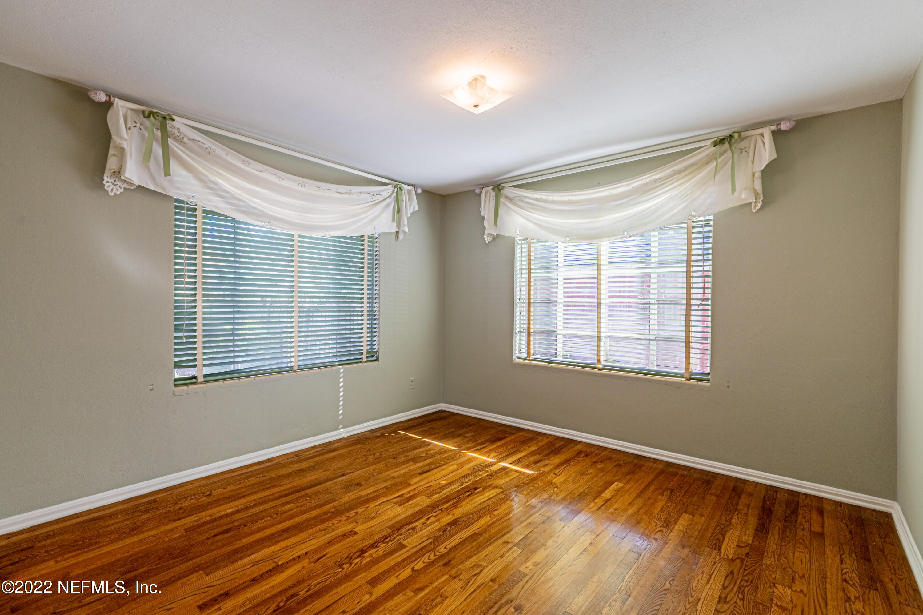 4209 Birmingham Road Jacksonville, FL 32207 - Photo 24 of 35 a view of an empty room with wooden floor and a window
