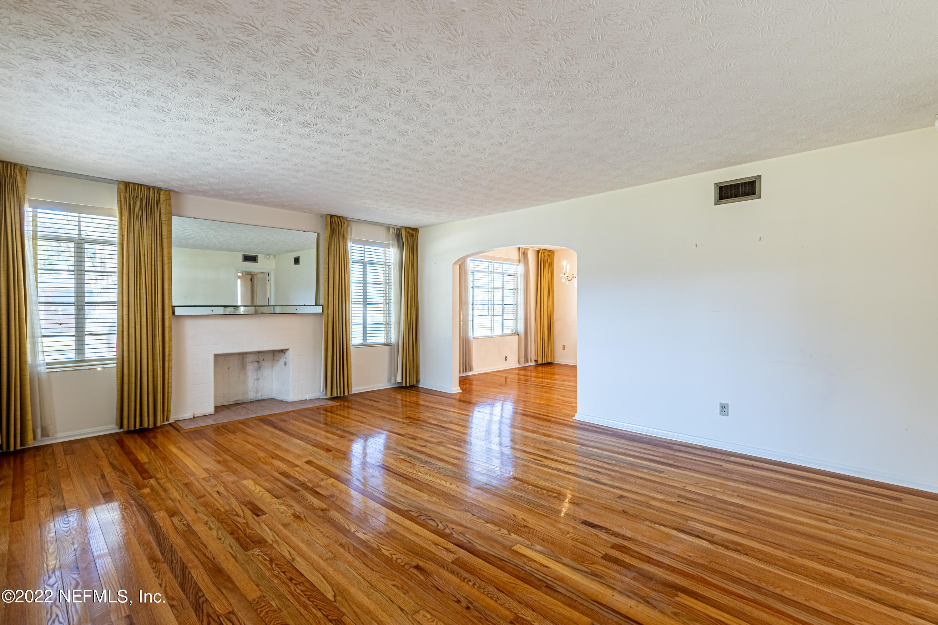 4209 Birmingham Road Jacksonville, FL 32207 - Photo 5 of 35 a view of an empty room with window and wooden floor