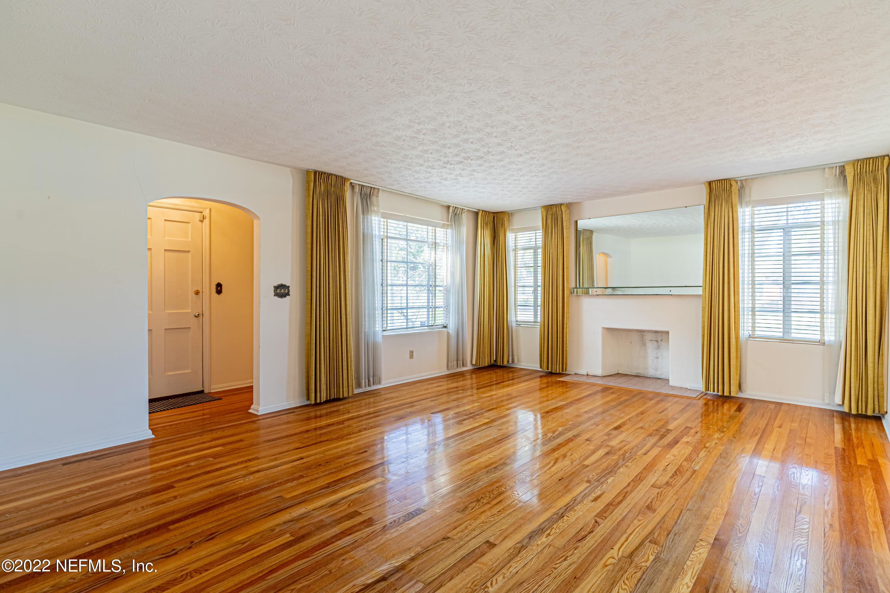 4209 Birmingham Road Jacksonville, FL 32207 - Photo 8 of 35 a view of an empty room with wooden floor and a window