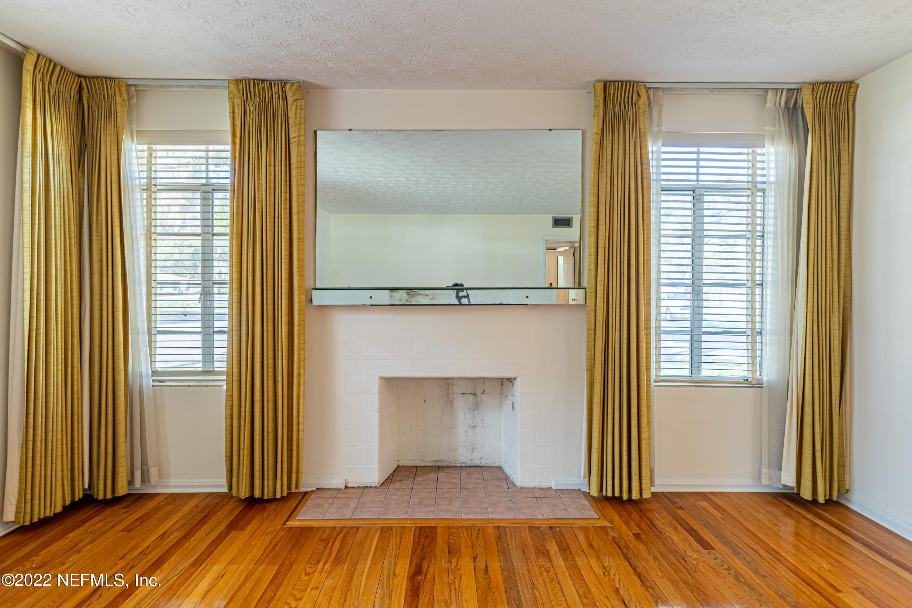 4209 Birmingham Road Jacksonville, FL 32207 - Photo 9 of 35 a view of a room with wooden floor and a fireplace