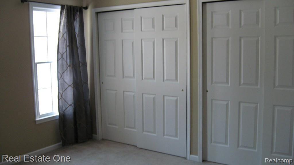 565 Timber Ridge Drive Highland, MI 48357 - Photo 30 of 55 BEDROOM 2 WITH MASSIVE CLOSET.
