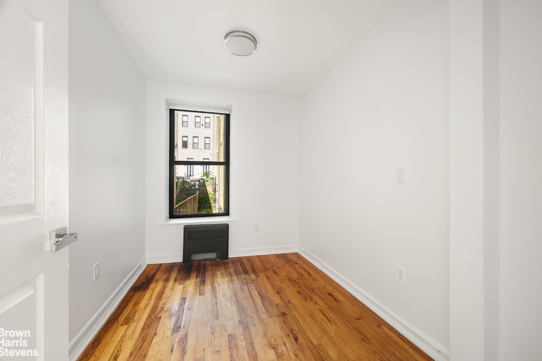29 West 119th Street, Unit 3 Manhattan, NY 10026 - Photo 2 of 14 a view of a hallway with wooden floor and a window