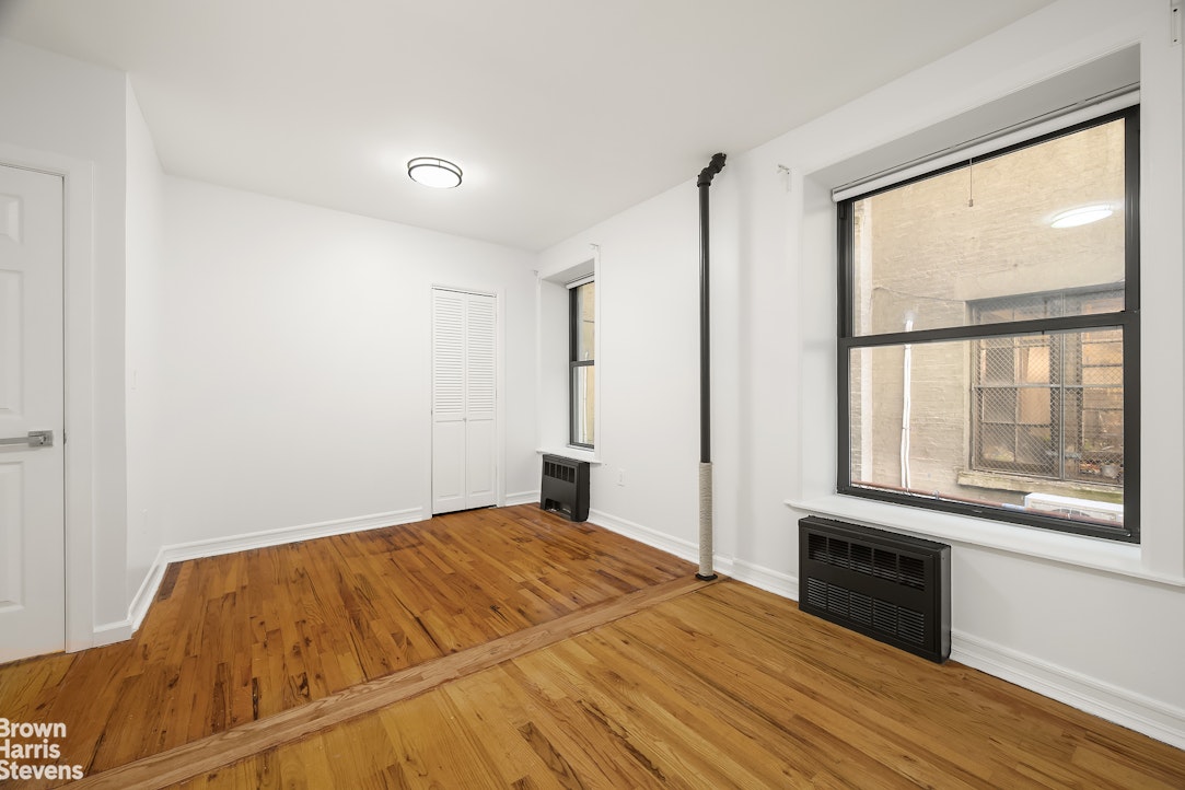 29 West 119th Street, Unit 3 Manhattan, NY 10026 - Photo 9 of 14 a bedroom with a bed and a large window