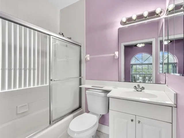 a bathroom with a sink a mirror and a bathtub