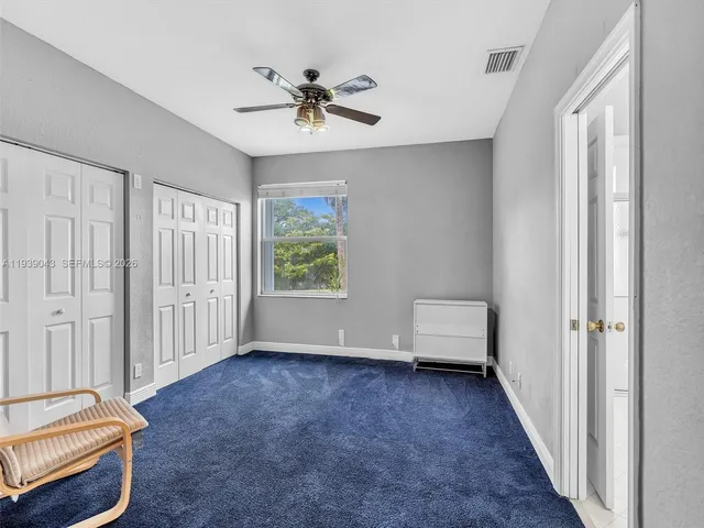 a bathroom with a sink mirror and toilet