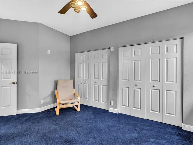 a bedroom with a bed dresser and a window