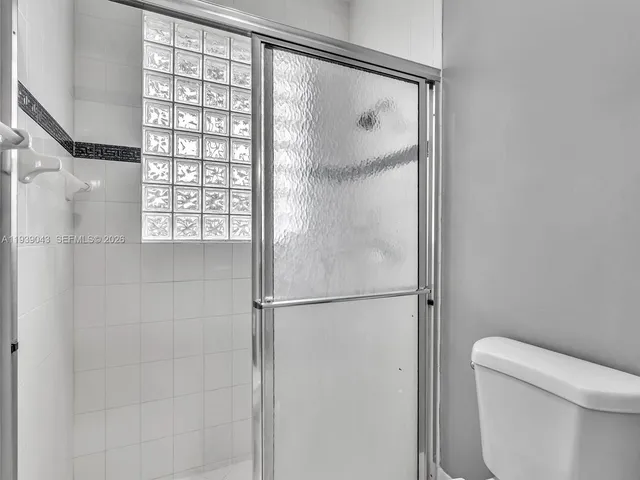 a large kitchen with stainless steel appliances granite countertop a sink and cabinets