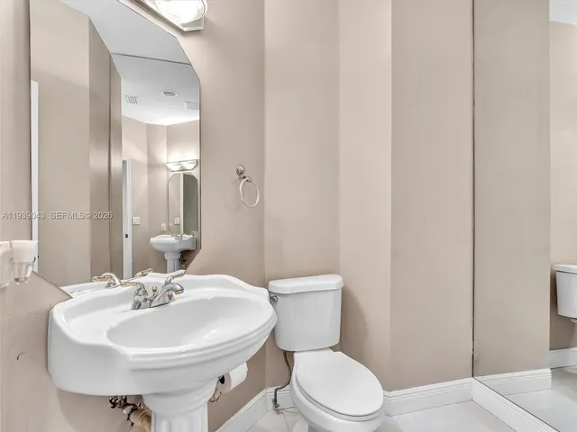 a large kitchen with a table and chairs
