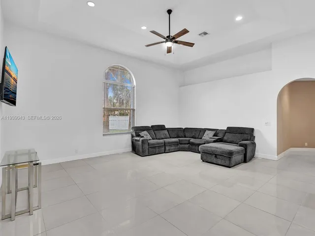 a house with green field in front of it