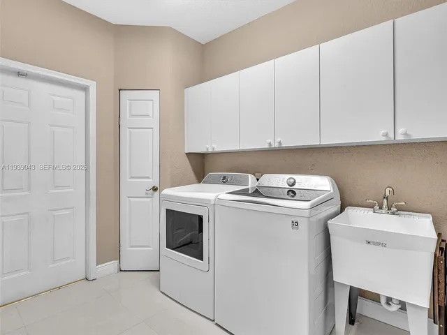 an aerial view of residential house with an outdoor space and swimming pool