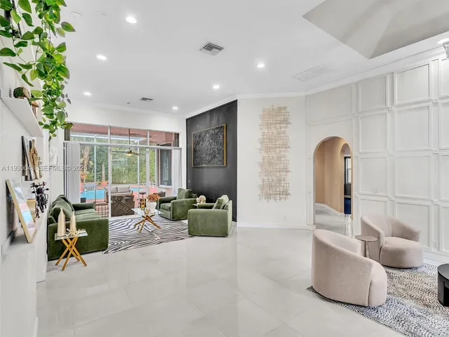 a living room with a couch and a chandelier
