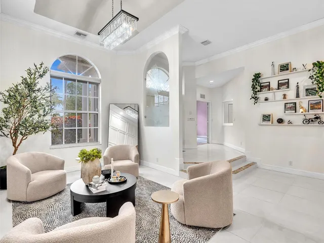 a living room with furniture potted plant and a window