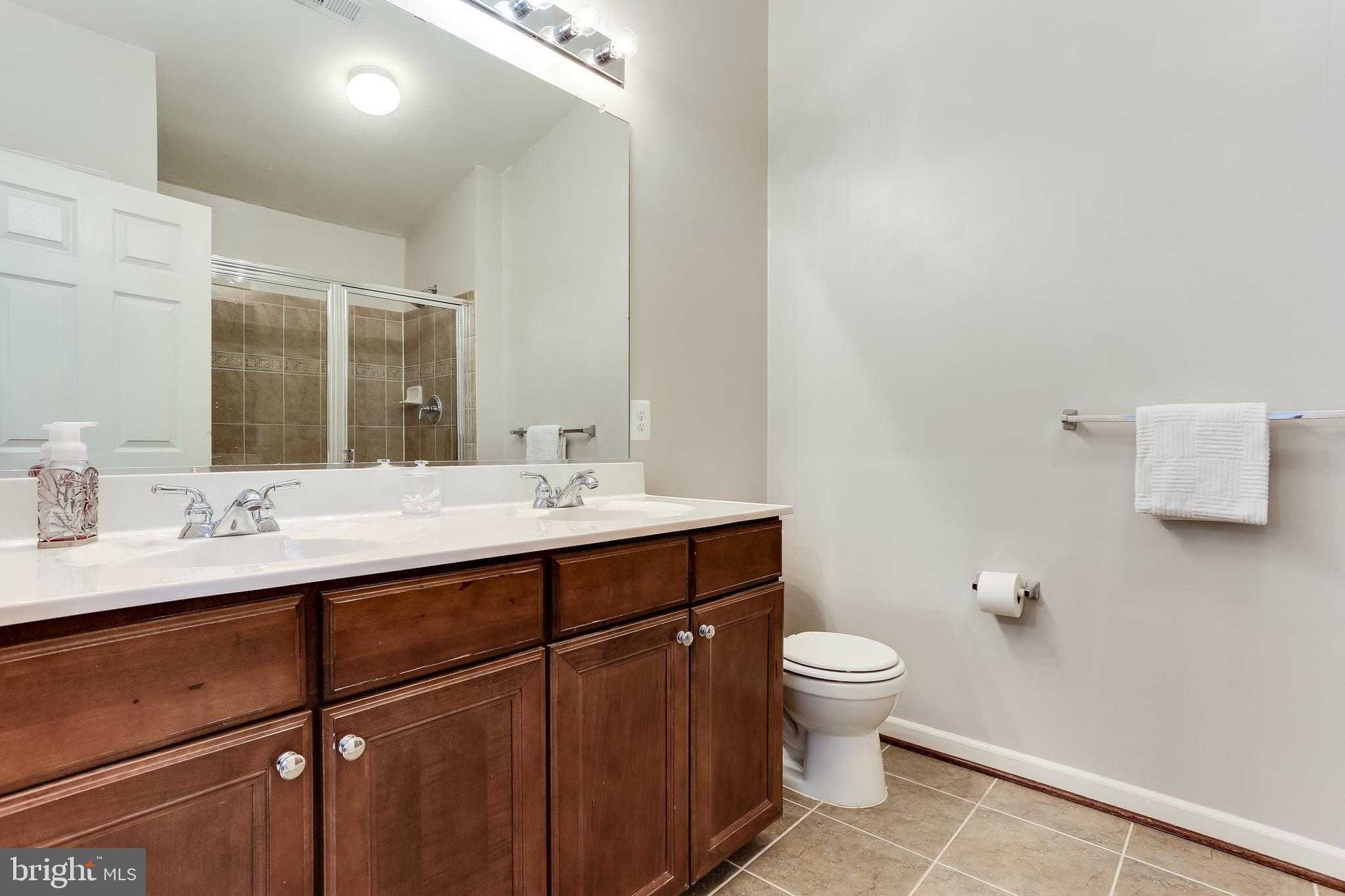 7128 Water Oak Road, Unit 244 Elkridge, MD 21075 - Photo 19 of 31 Owners bathroom w/ double vanity and shower heads