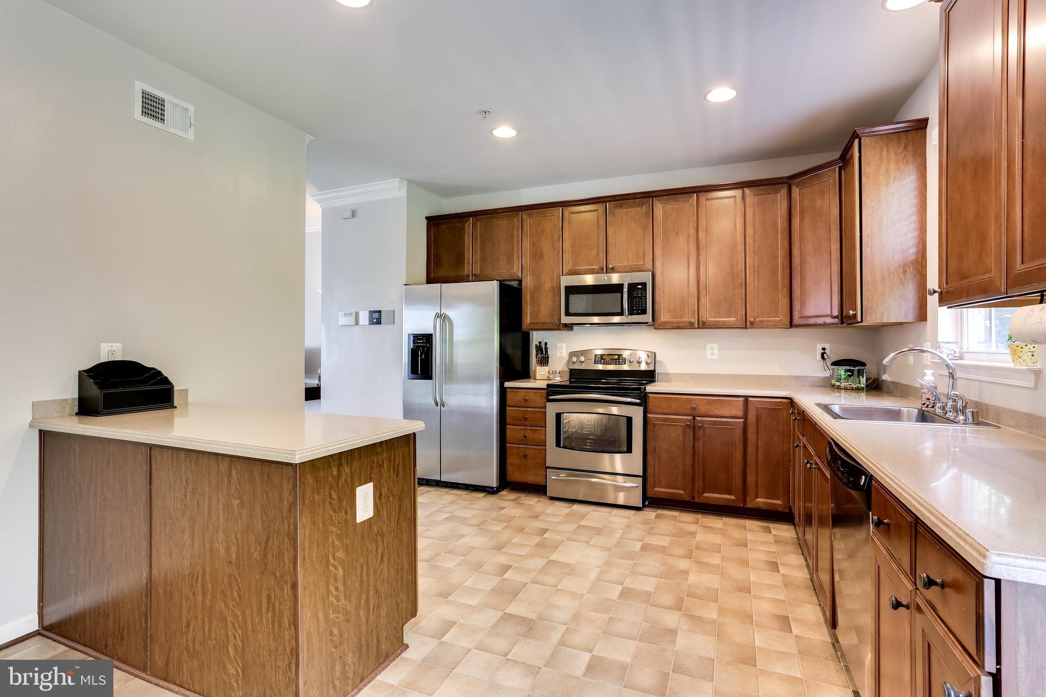 7128 Water Oak Road, Unit 244 Elkridge, MD 21075 - Photo 9 of 31 SS appliances and upgraded dark honey cabinetry