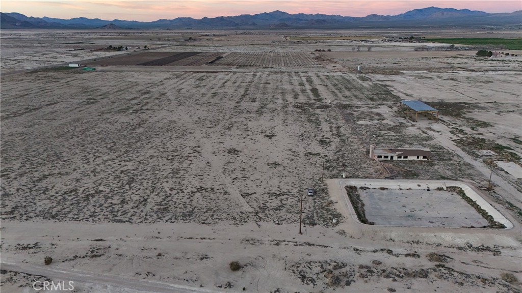 12148 Wilshire Road Lucerne Valley, CA 92356 - Photo 26 of 29 a view of a dry yard with mountain and trees