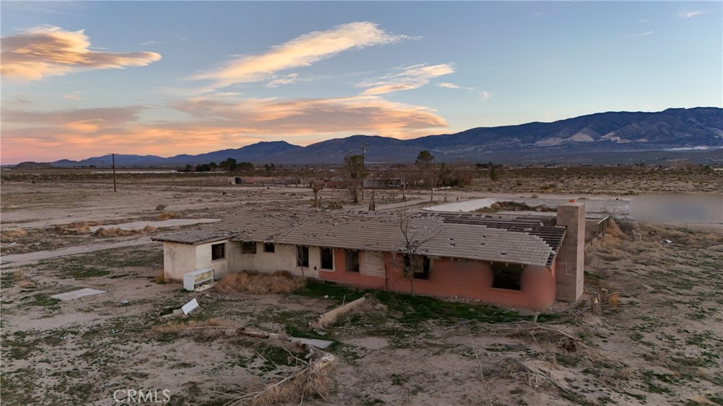 12148 Wilshire Road Lucerne Valley, CA 92356 - Photo 8 of 29 a view of a house with a mountain yard and mountain view