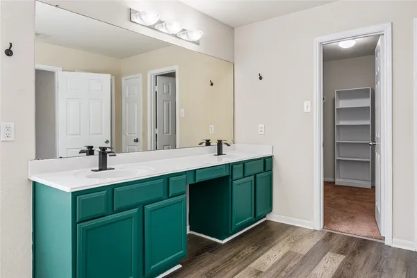 a bathroom with a tub sink and mirror
