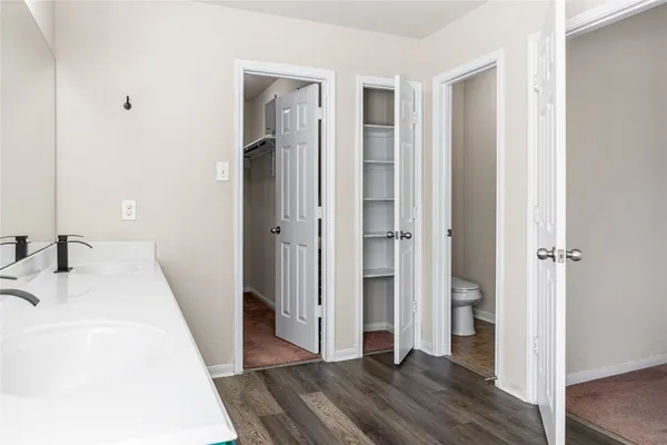 a view of walk in closet with empty racks