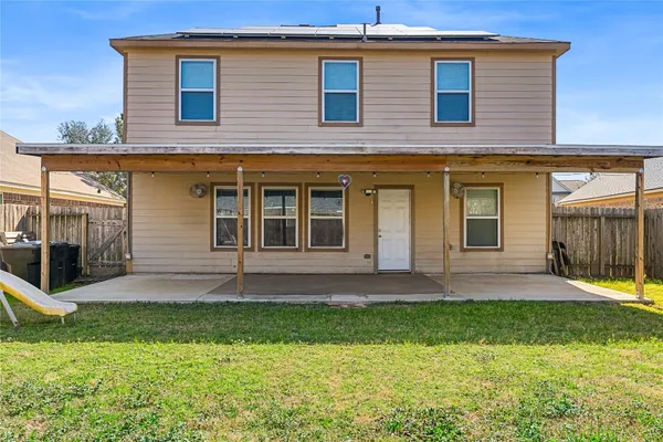 a view of an house with backyard and porch