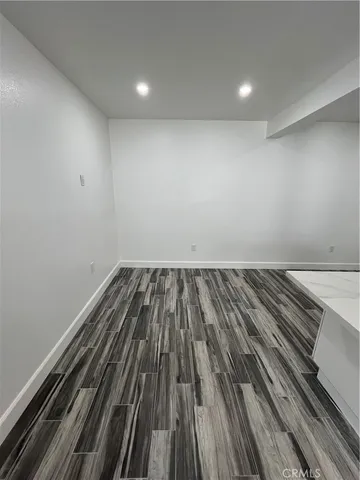 a room with wooden floor and furniture