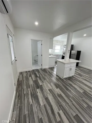 a view of an empty room and wooden floor