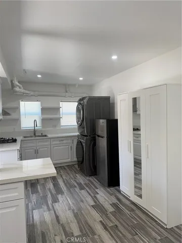 a kitchen with stainless steel appliances a refrigerator and a sink