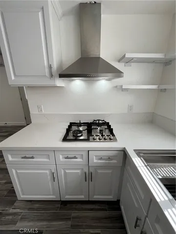 a white stove top oven sitting inside of a kitchen