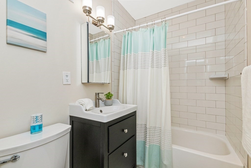 28 Juniper Street, Unit 79 Brookline, MA 02445 - Photo 12 of 23 a bathroom with a sink and a mirror