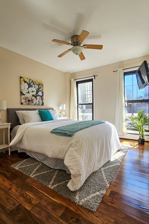 28 Juniper Street, Unit 79 Brookline, MA 02445 - Photo 3 of 23 a bedroom with a bed and wooden floor