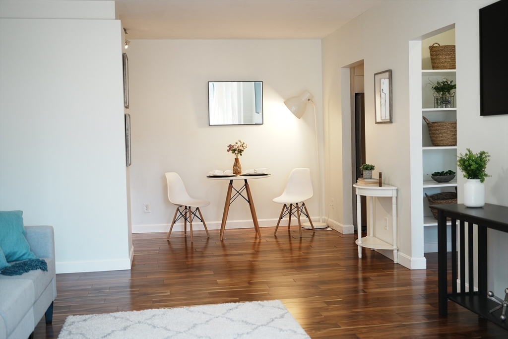 28 Juniper Street, Unit 79 Brookline, MA 02445 - Photo 7 of 23 a view of a dining room with furniture and wooden floor
