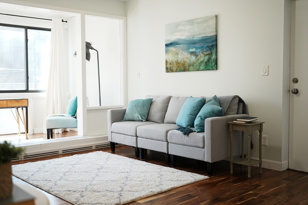 28 Juniper Street, Unit 79 Brookline, MA 02445 - Photo 9 of 23 a living room with furniture and a large window