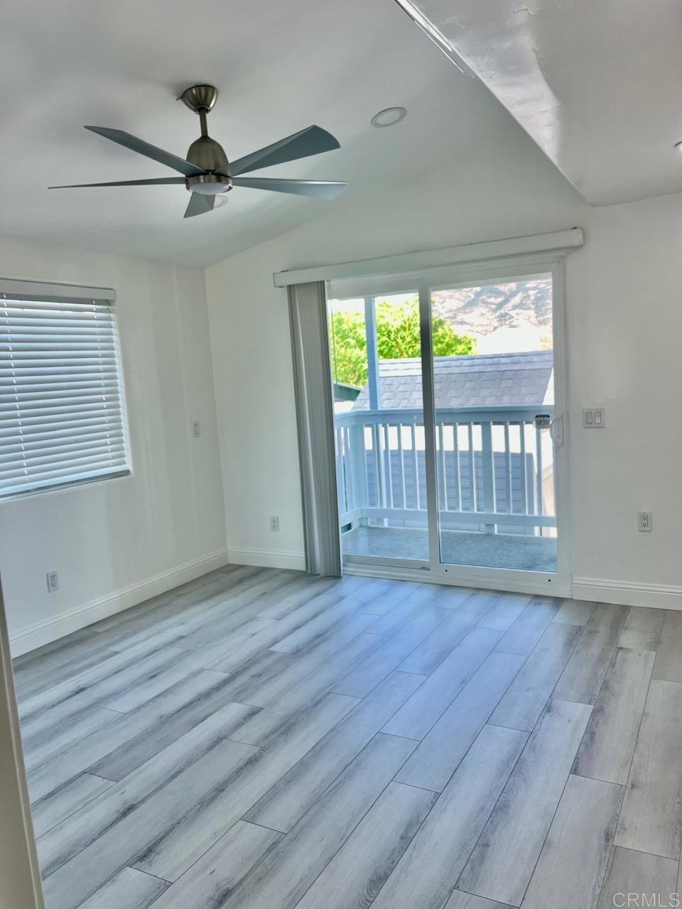 9902 Jamacha Boulevard, Unit 160 Spring Valley, CA 91977 - Photo 6 of 18 an empty room with wooden floor fan and windows
