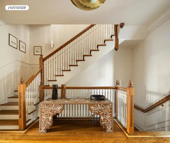 a view of staircase with lots of frames on wall
