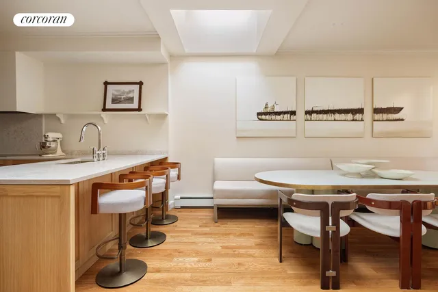 a kitchen with a sink cabinets and wooden floor