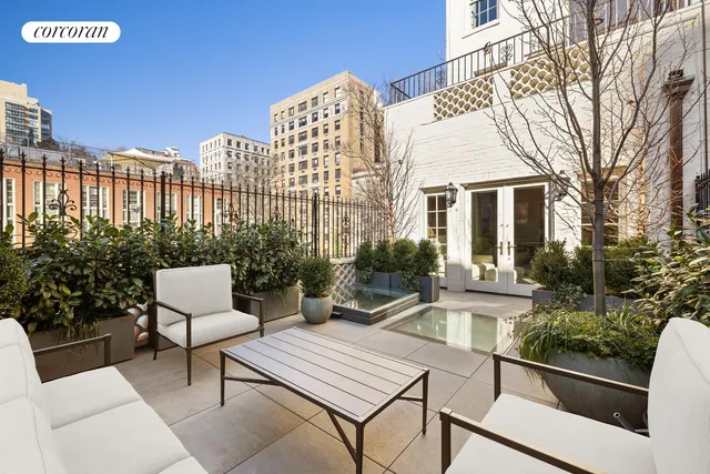 a view of a patio with couches table and chairs and potted plants