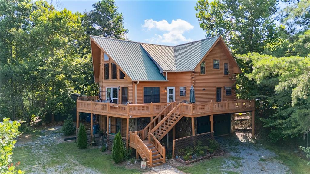 a front view of a house with a tree