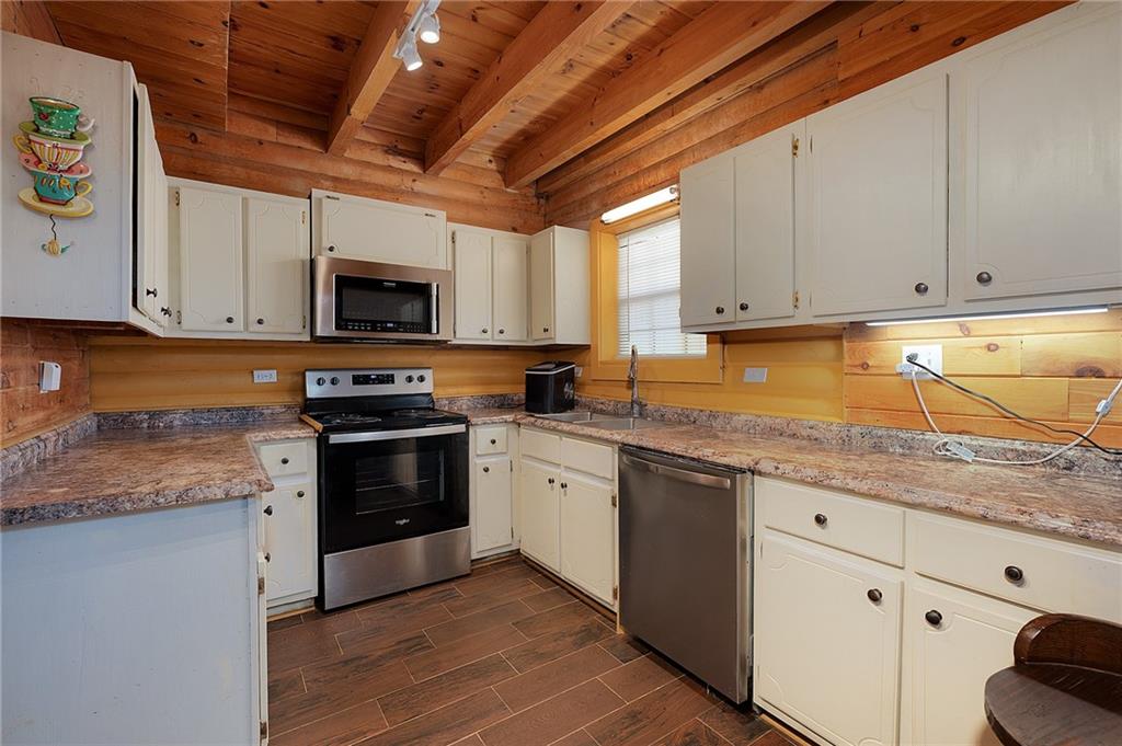 1001 Liberty Church Road Northeast Ranger, GA 30734 - Photo 18 of 40 a kitchen with granite countertop a sink cabinets and stainless steel appliances