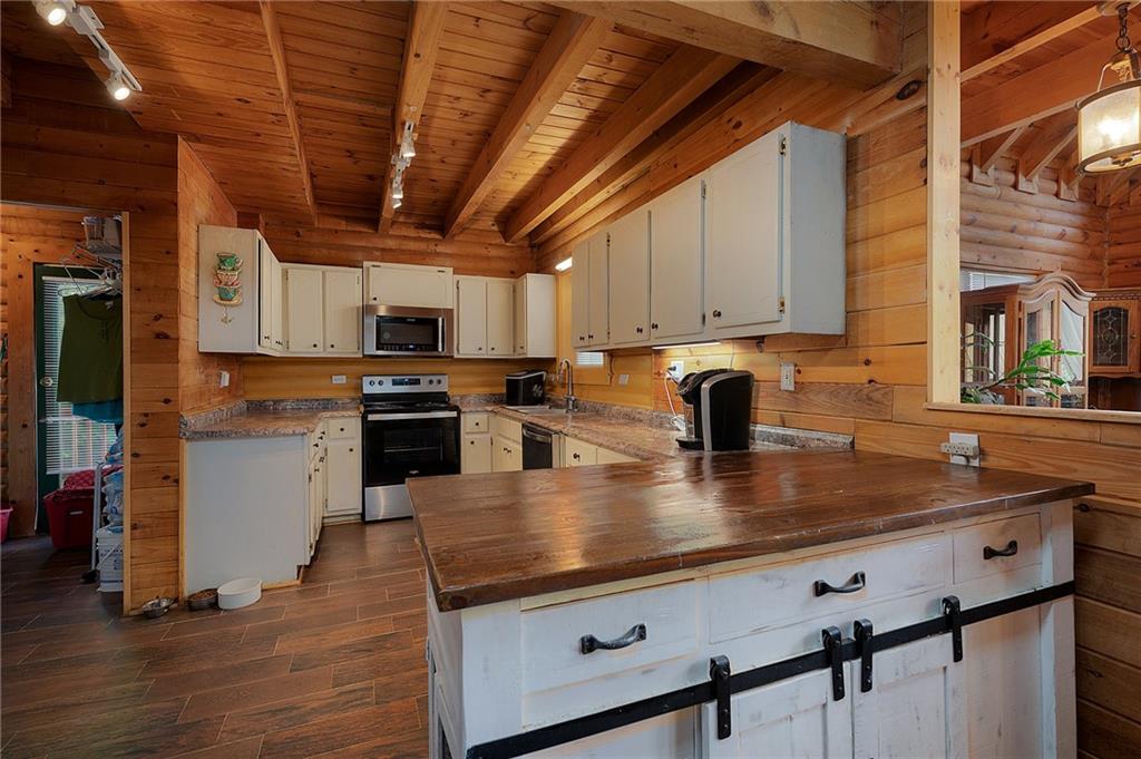 1001 Liberty Church Road Northeast Ranger, GA 30734 - Photo 19 of 40 a kitchen with stainless steel appliances granite countertop a sink a stove and cabinets