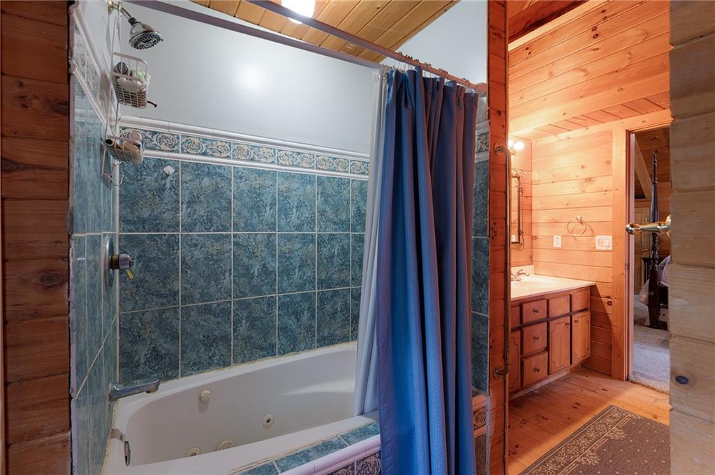 1001 Liberty Church Road Northeast Ranger, GA 30734 - Photo 36 of 40 a bathroom with a bathtub and a shower