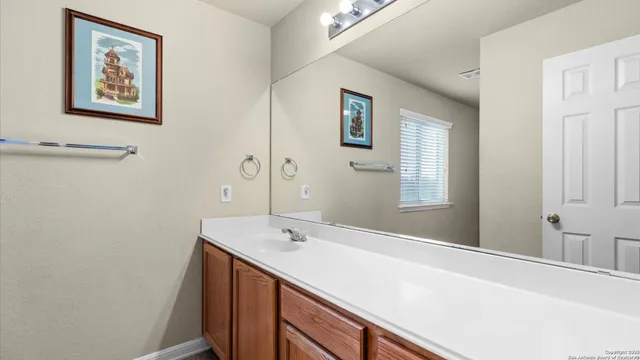 a bathroom with a sink and a mirror
