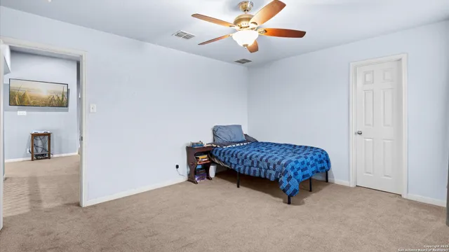 a bedroom with a bed and a lamp