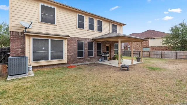 a view of a house with backyard porch and sitting area